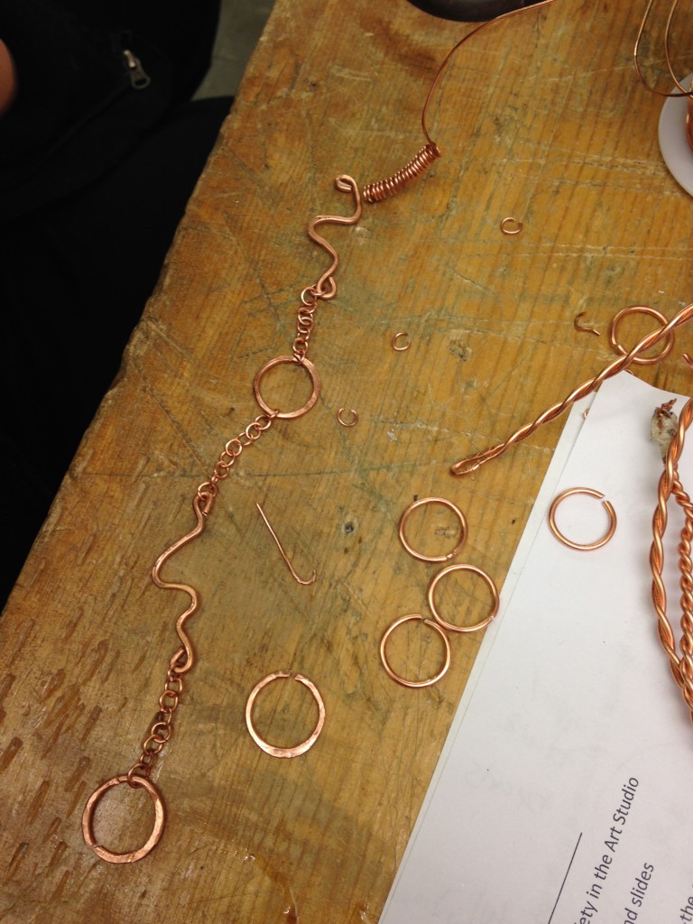Jasmine's necklace is built with hand-formed wire segments and chain.